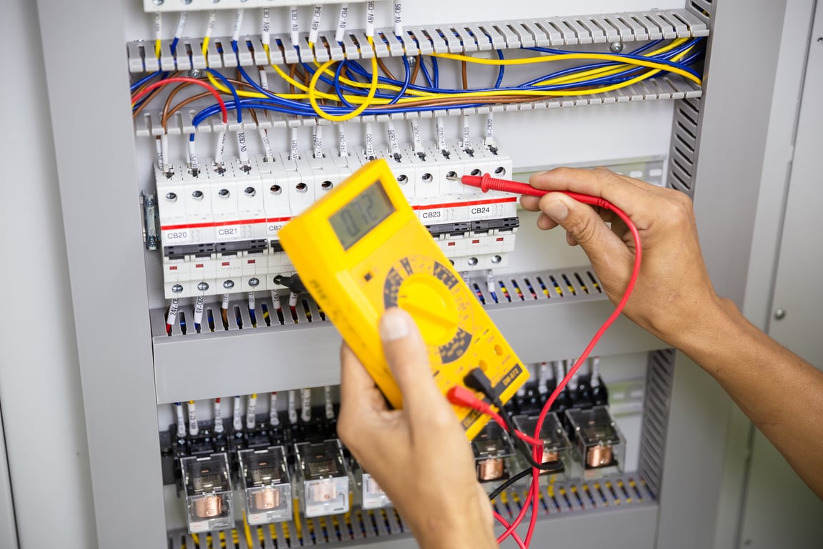 Technician Using a Multimeter on a Switchgear